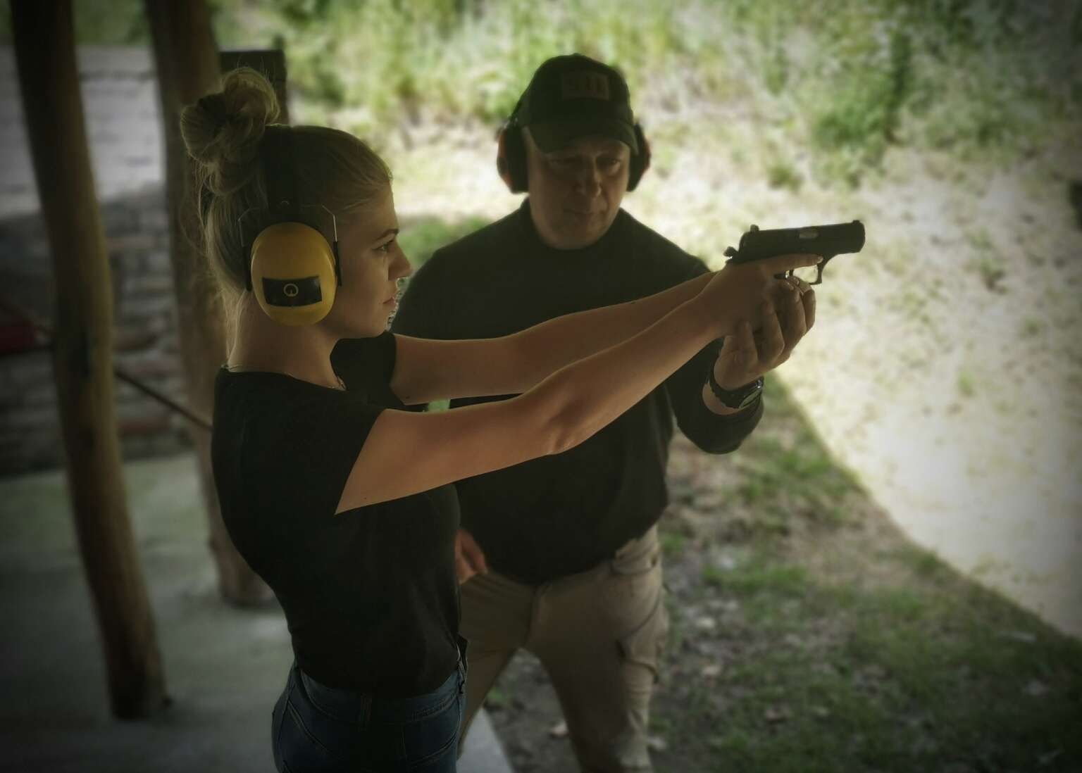 Instructor supporting a participant during firearms training